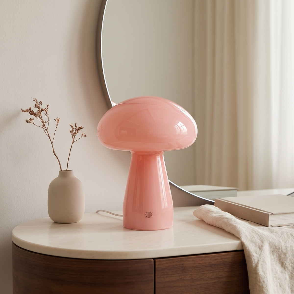 Pink glass mushroom lamp on a styled console